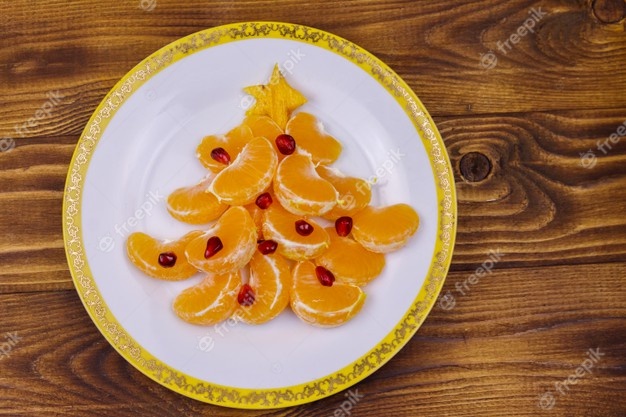 christmas-tree-made-of-mandarin-lobules-and-pomegranate-on-wooden-table-top-view-creative-idea-for-christmas-and-new-year-festive-desserts-funny-food-idea-for-kids_491799-1128.jpg